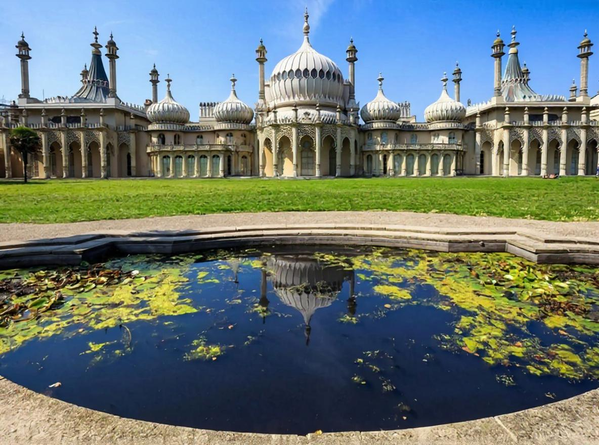 An ornate imagined palace reflected in a lily pond